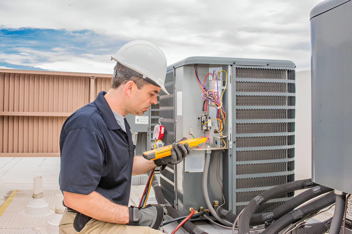 Skilled professional testing AC wiring and components during an AC Fix service call.