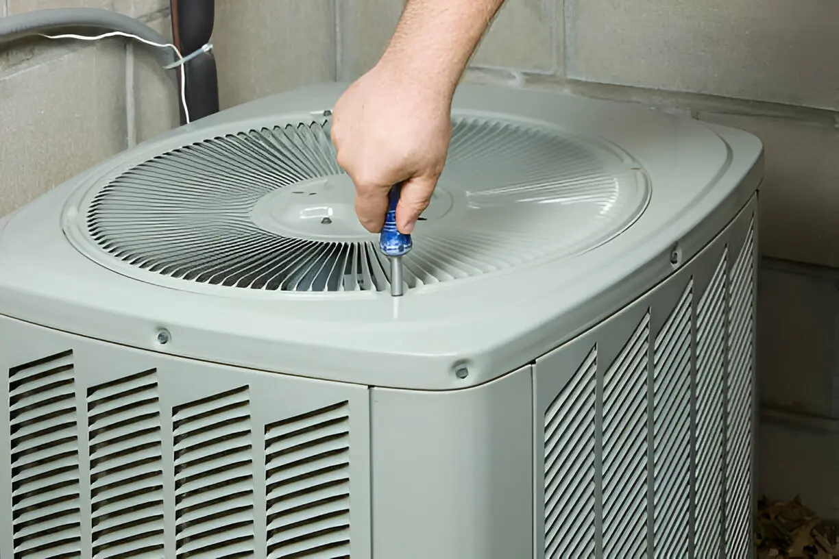 HVAC technician fixing a broken air conditioner efficiently