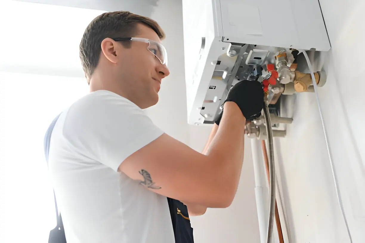 Technician working on combined heating and air conditioning system